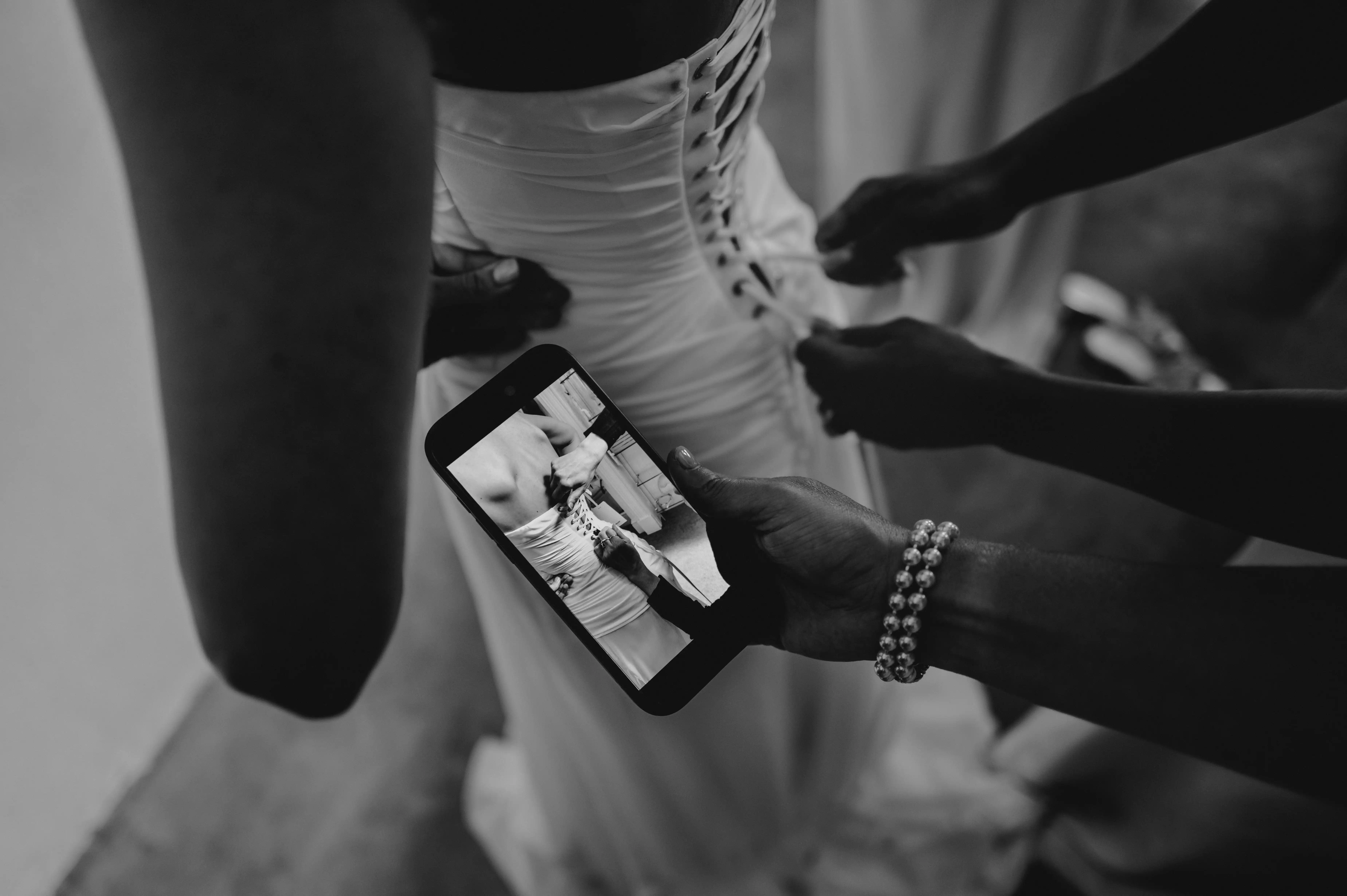 Bridal corset lacing detail captured in artistic black and white wedding photography